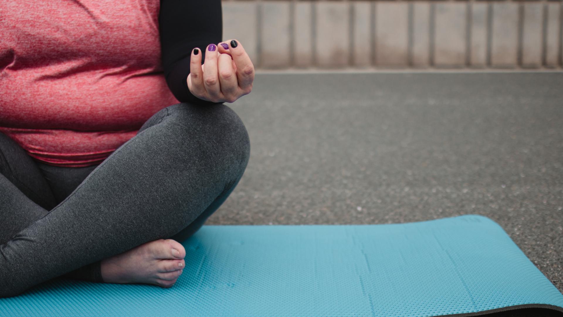Woman sitting on yoga mat
