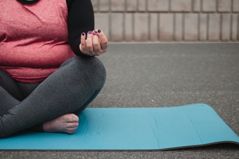 Woman sitting on yoga mat